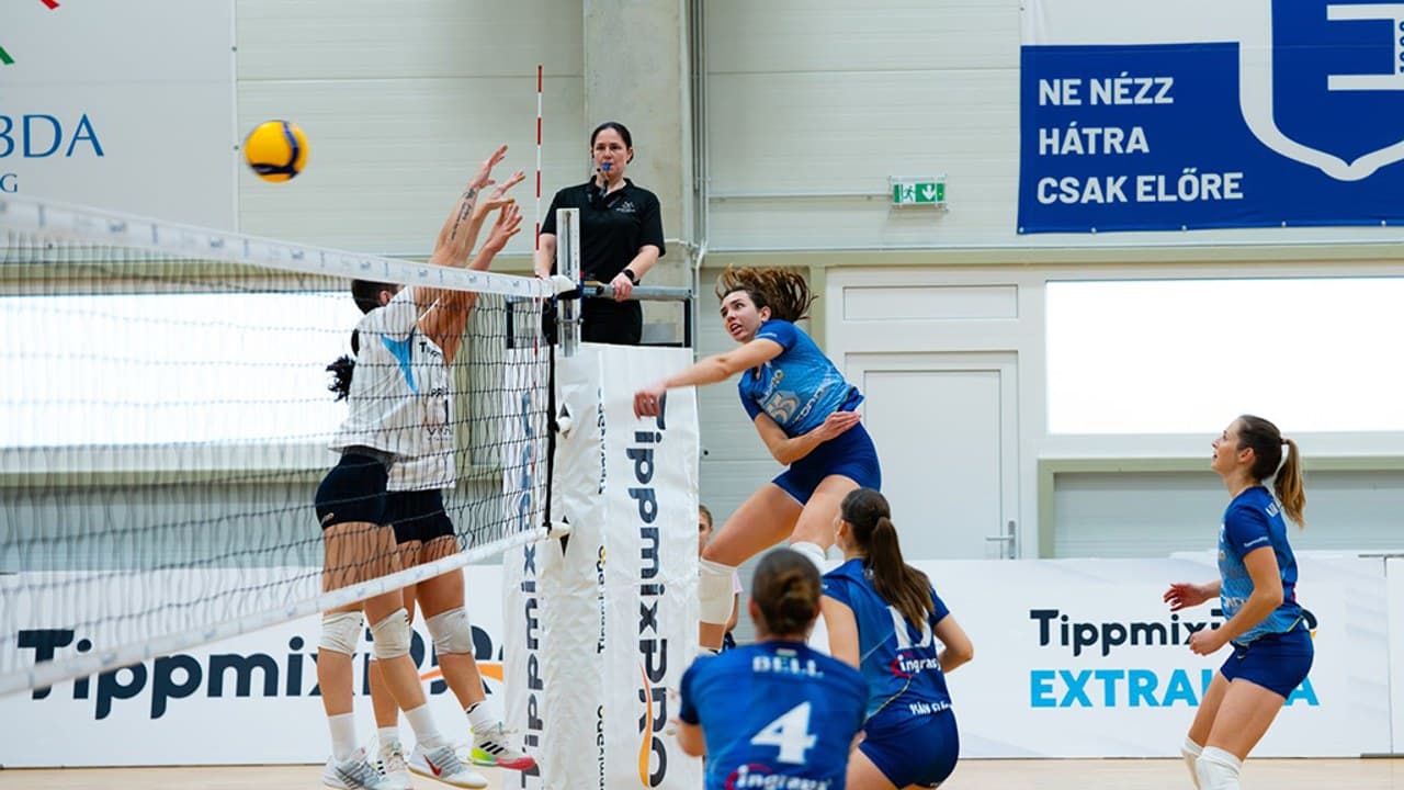 Női Extraliga röplabda mérkőzésen a TFSE játékosa üt a MÁV Előre blokkja ellen.