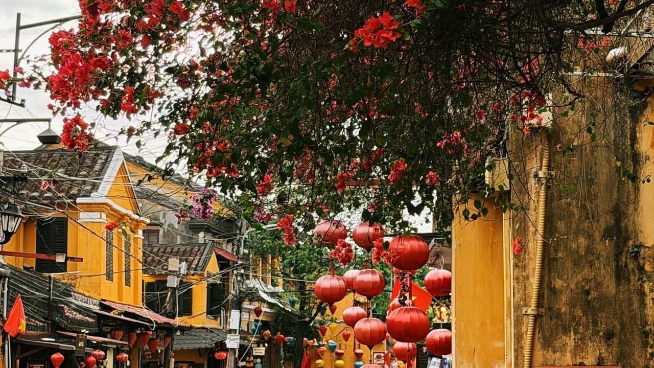 Hoi An nyüzsgő utcája sárga épületekkel, lampionokkal és riksákkal, a vietnámi utcai ételek paradicsoma. – 2. kép